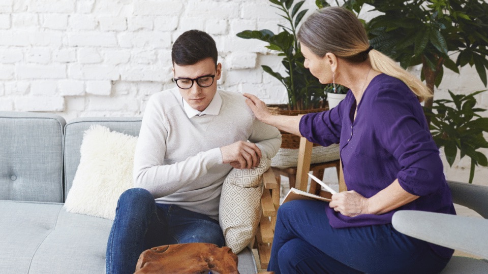 A clinician and patient in a supportive conversation about recovery
