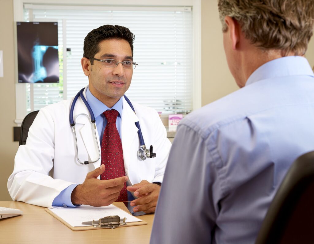 A male doctor speaking quietly with a patient about Sublocade treatment