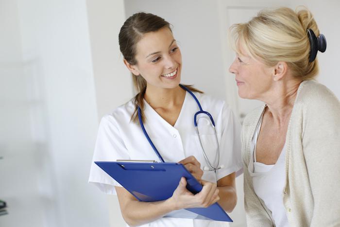 A clinician and patient seated together discussing the next step in recovery